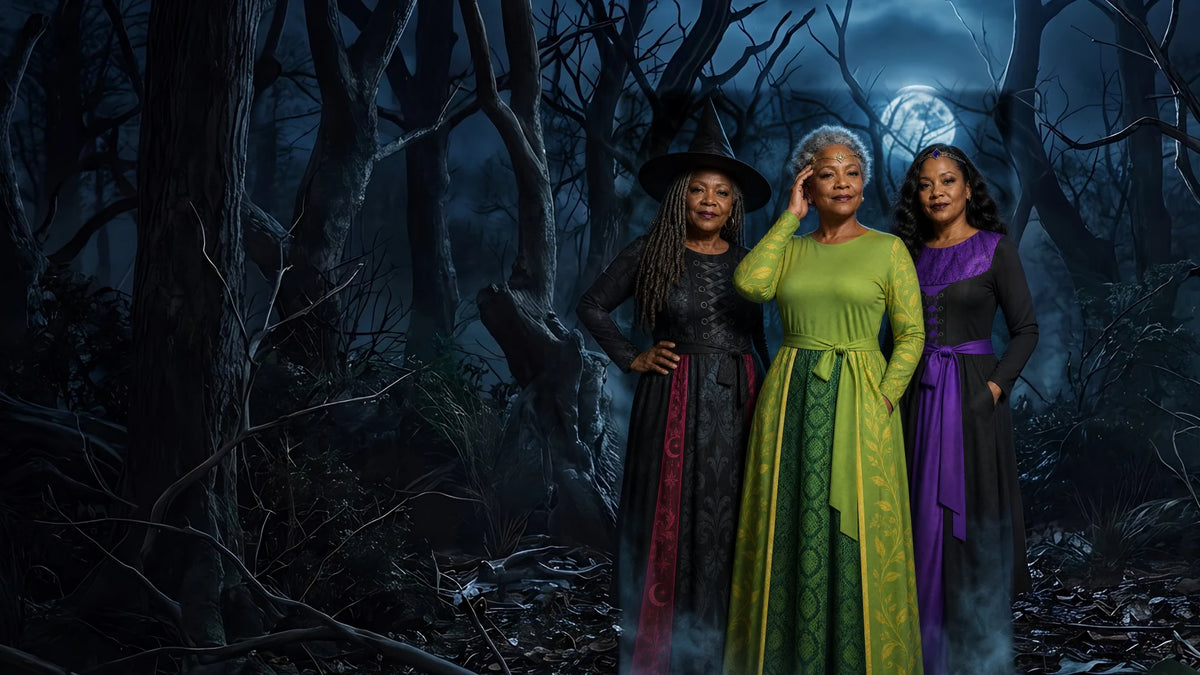 Three women in Witch, Medusa and Sorceress printed costume dresses in a moonlit forest