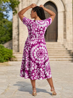 "Anasa" Sweetheart Midi Dress — back view on model in the churchyard