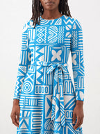 "Anga" Long Sleeve Midaxi Dress — close-up of the tie sash and the in-seam side pocket