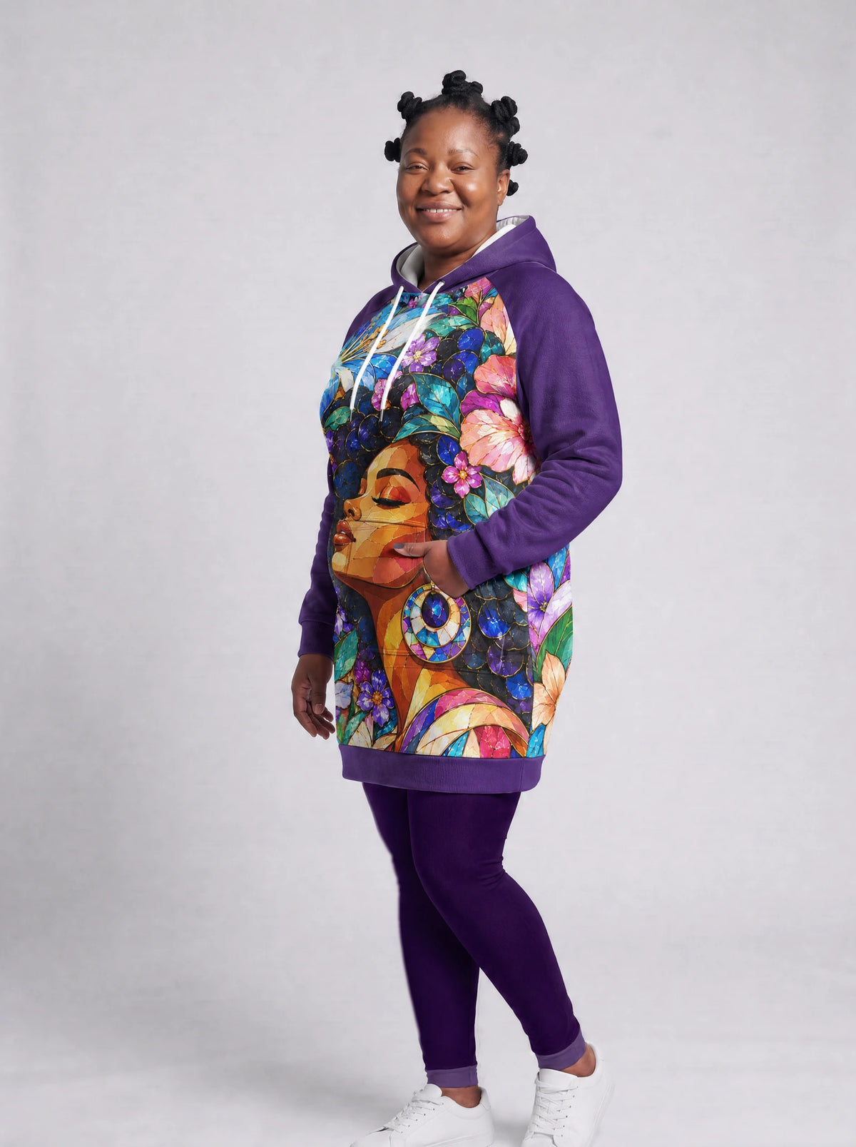 "Dirisha" Hoodie Dress — three-quarter view on a plus-size model, hand in pocket, styled with the matching leggings