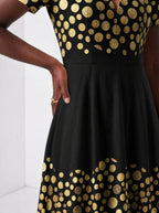 "Giza" Short Sleeve Maxi Dress — standing, angled view on model