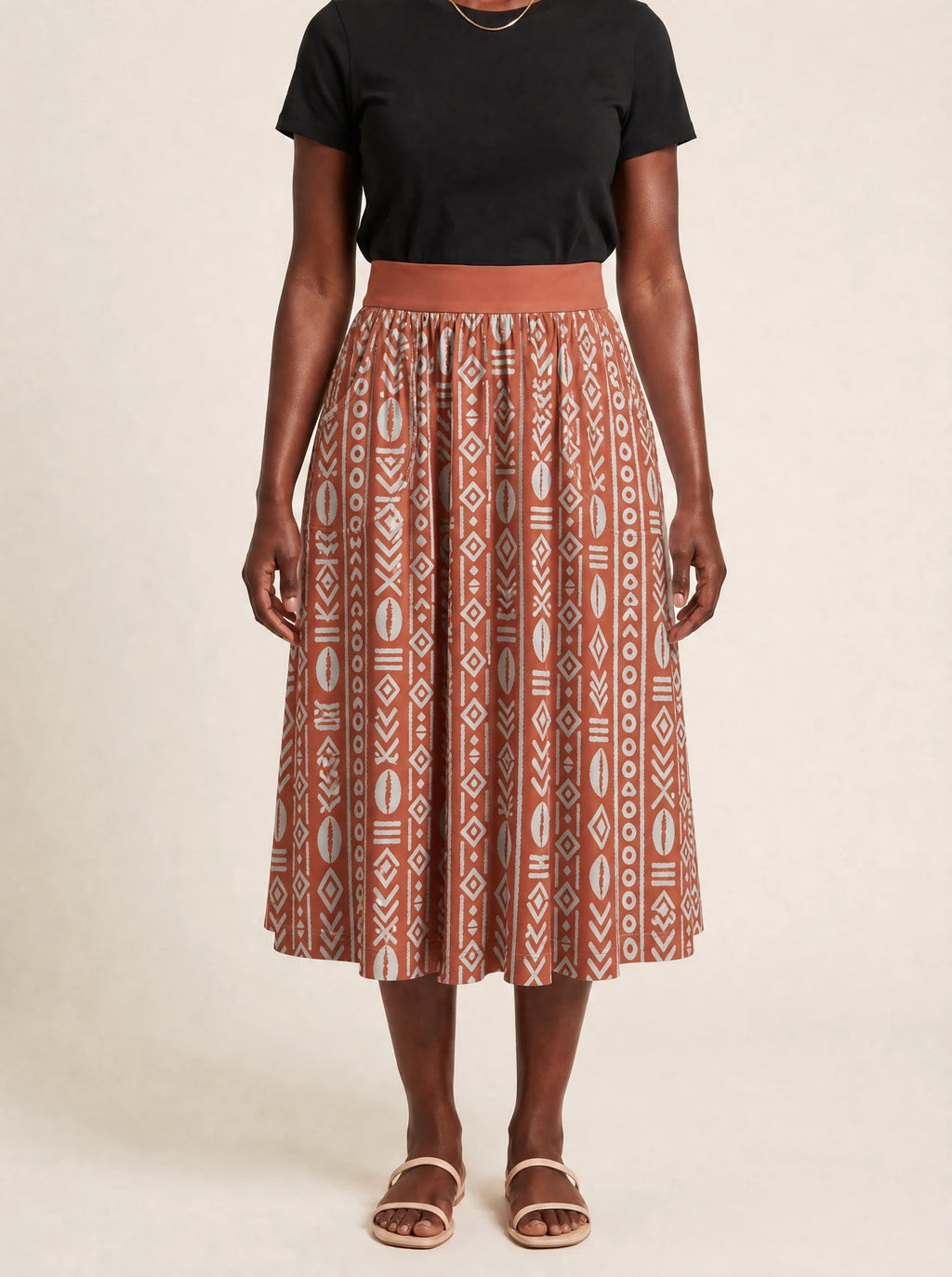 "Oshun Kijani" Twirl Skirt — cropped front view on model