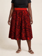 "Shaka Burgundy" Twirl Skirt — cropped front view on model