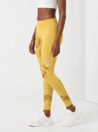 Yellow Orchid Leggings — side view on model