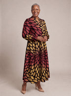 "Mavuno" Long Puff Sleeve Dress — walking, three-quarter view on model