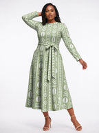 "Oshun Verde" Viscose Midi Dress — three-quarter view on model, hand in the side pocket