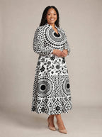 "Mwanga" Long Puff Sleeve Dress — walking, three-quarter view on model