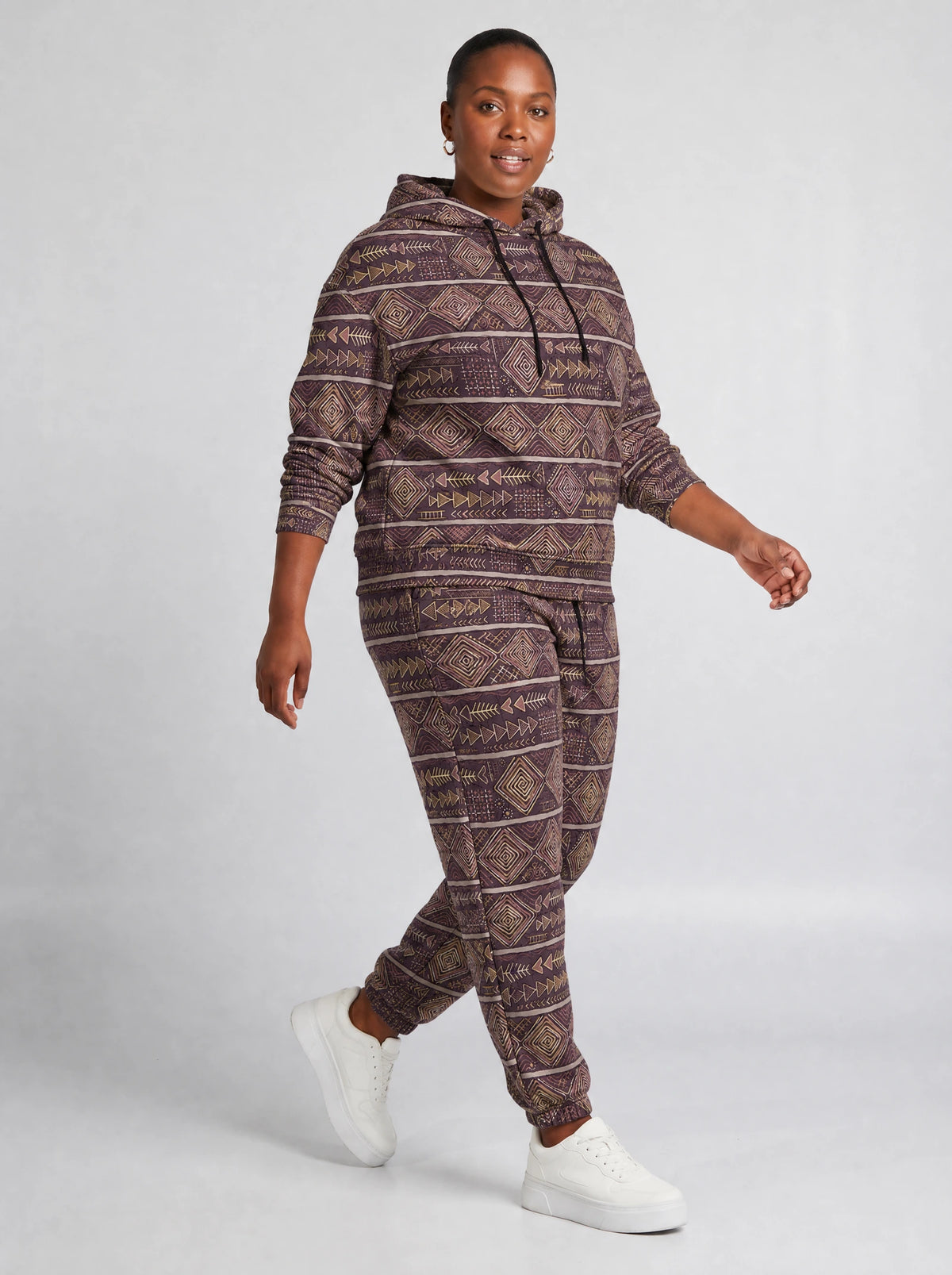 "Tabaka" Plum Gold Hoodie & Jogger Set — walking three-quarter view on model