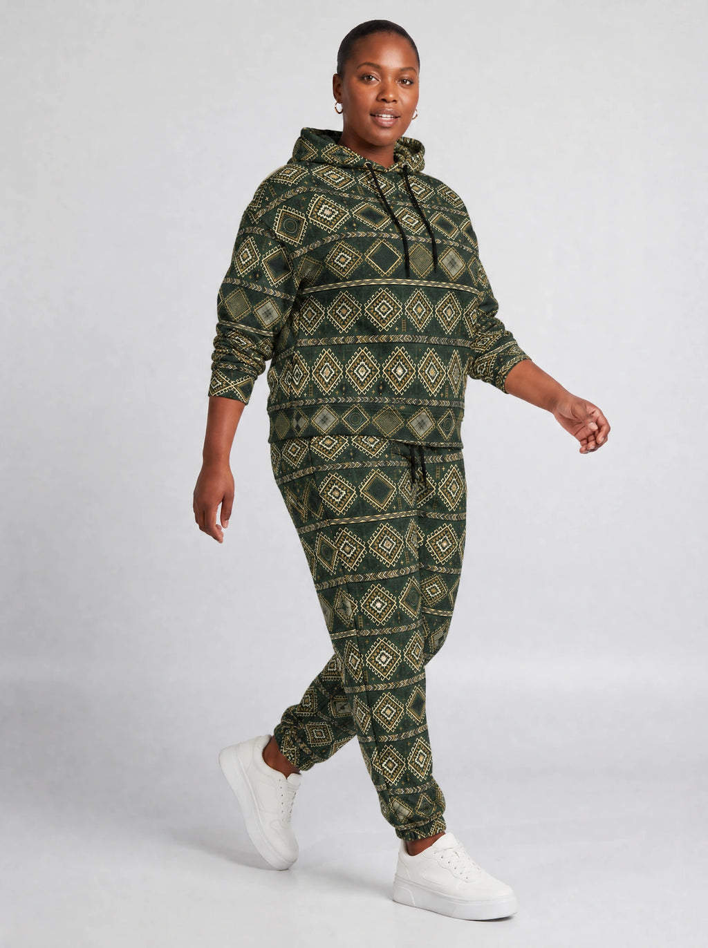 "Kilele" Forest Brass Hoodie & Jogger Set — walking three-quarter view on model