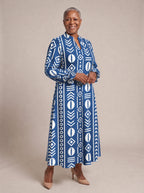 "Oshun" Royal Blue Long Puff Sleeve Dress — walking, three-quarter view on model
