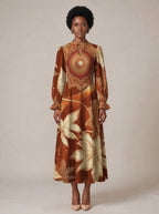 "Joto" Long Puff Sleeve Dress — standing, angled view on model