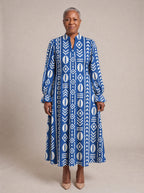 "Oshun" Royal Blue Long Puff Sleeve Dress — standing, angled view on model