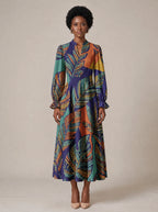 "Majani" Long Puff Sleeve Dress — standing, angled view on model