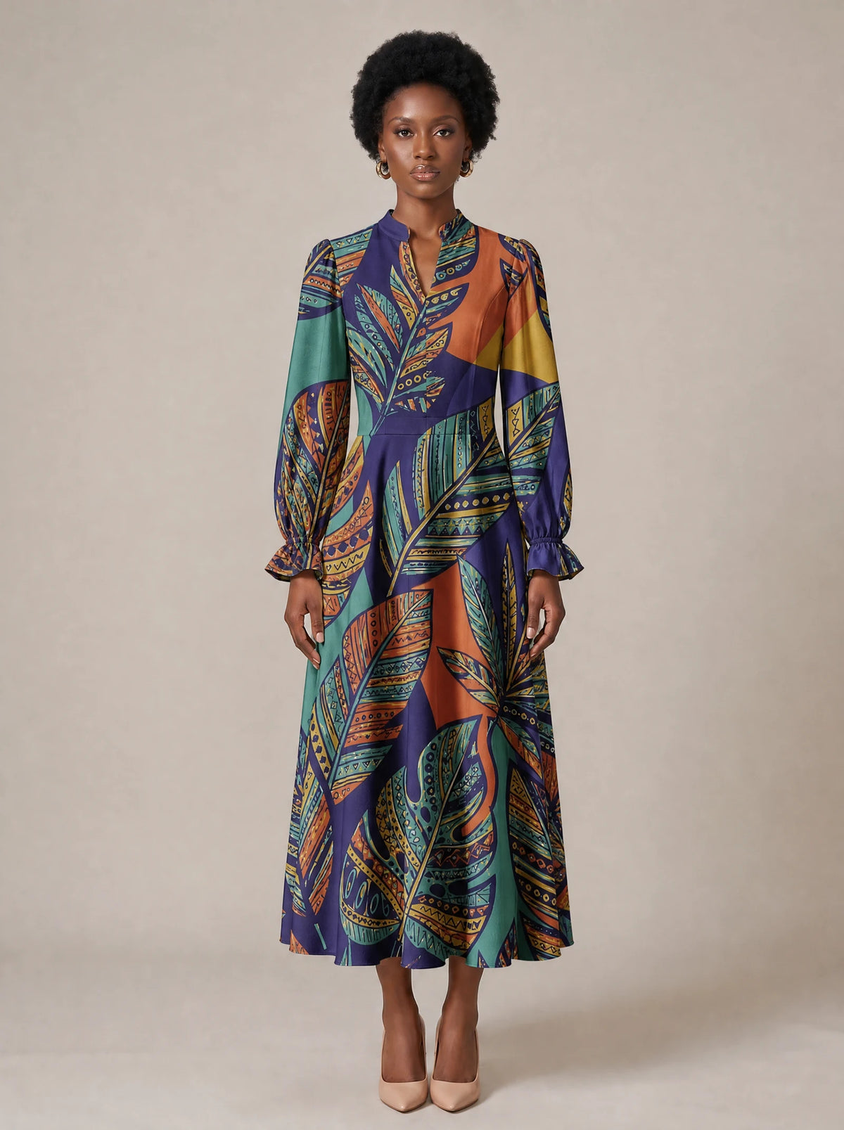 "Majani" Long Puff Sleeve Dress — standing, angled view on model
