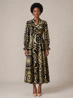 "Sahara" Long Puff Sleeve Dress — standing, angled view on model