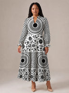 "Mwanga" Long Puff Sleeve Dress — standing, angled view on model