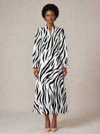 "Milia" Long Puff Sleeve Dress — standing, angled view on model