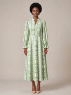 "Oshun Verde" Long Puff Sleeve Dress — standing, angled view on model