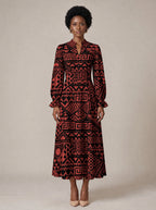 "Shaka" Burgundy Long Puff Sleeve Dress — standing, angled view on model