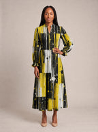 "Mvua" Long Puff Sleeve Dress — standing, angled view on model