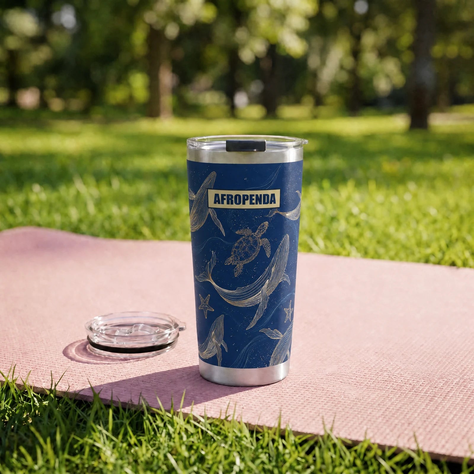"Pwani" Tumbler — on a yoga mat on a park lawn