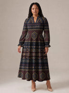 "Msuko" Long Puff Sleeve Dress — standing, angled view on model