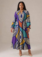 "Johari" Long Puff Sleeve Dress — standing, angled view on model
