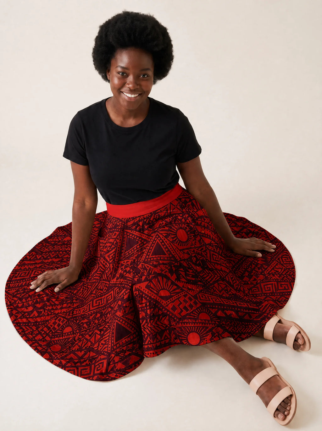 "Shaka Burgundy" Twirl Skirt — seated on the floor with the skirt fanned out