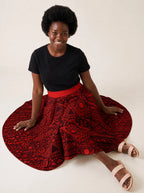 "Shaka Burgundy" Twirl Skirt — seated on the floor with the skirt fanned out