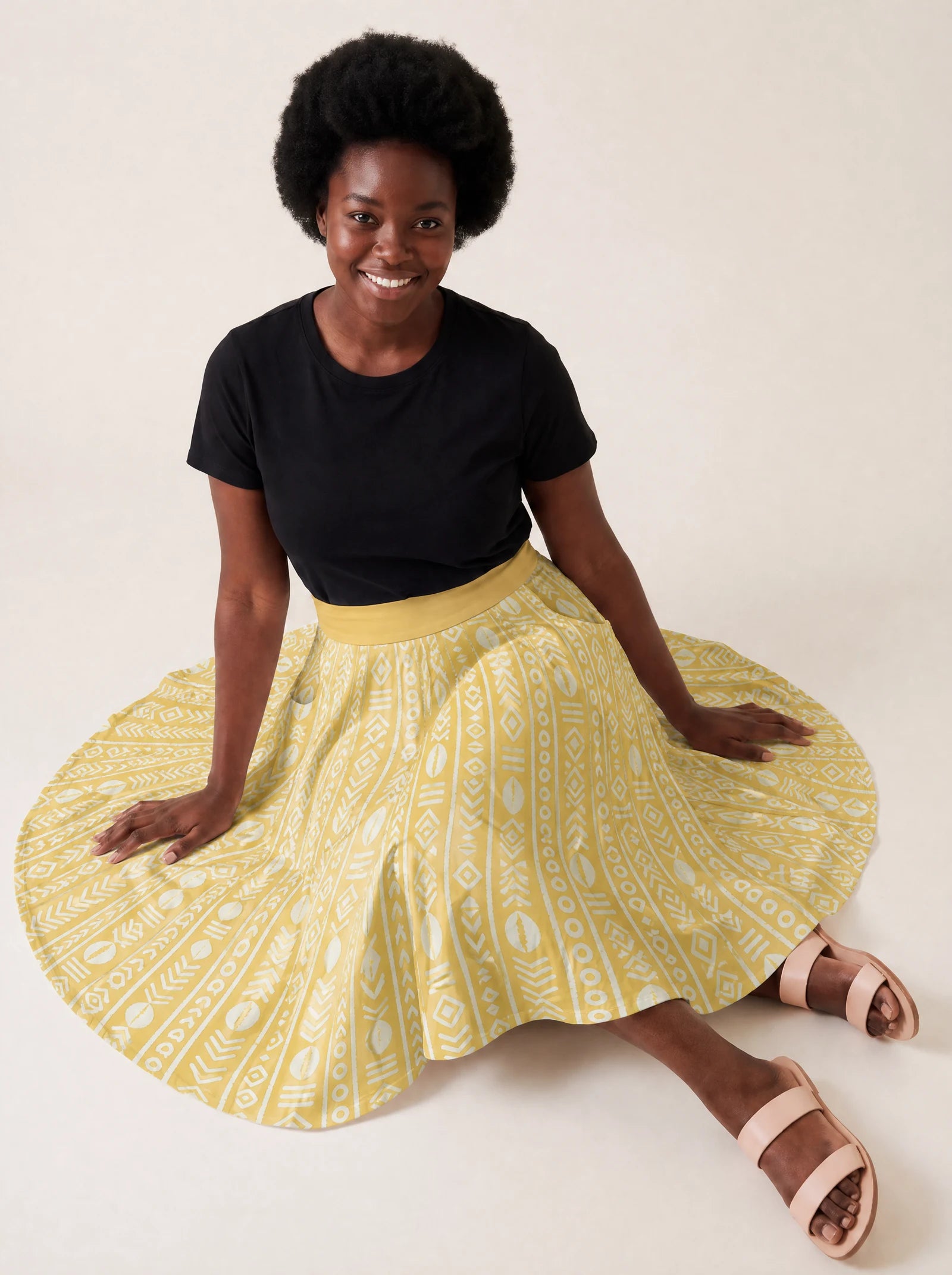 "Oshun Dhahabu" Twirl Skirt — seated on the floor with the skirt fanned out