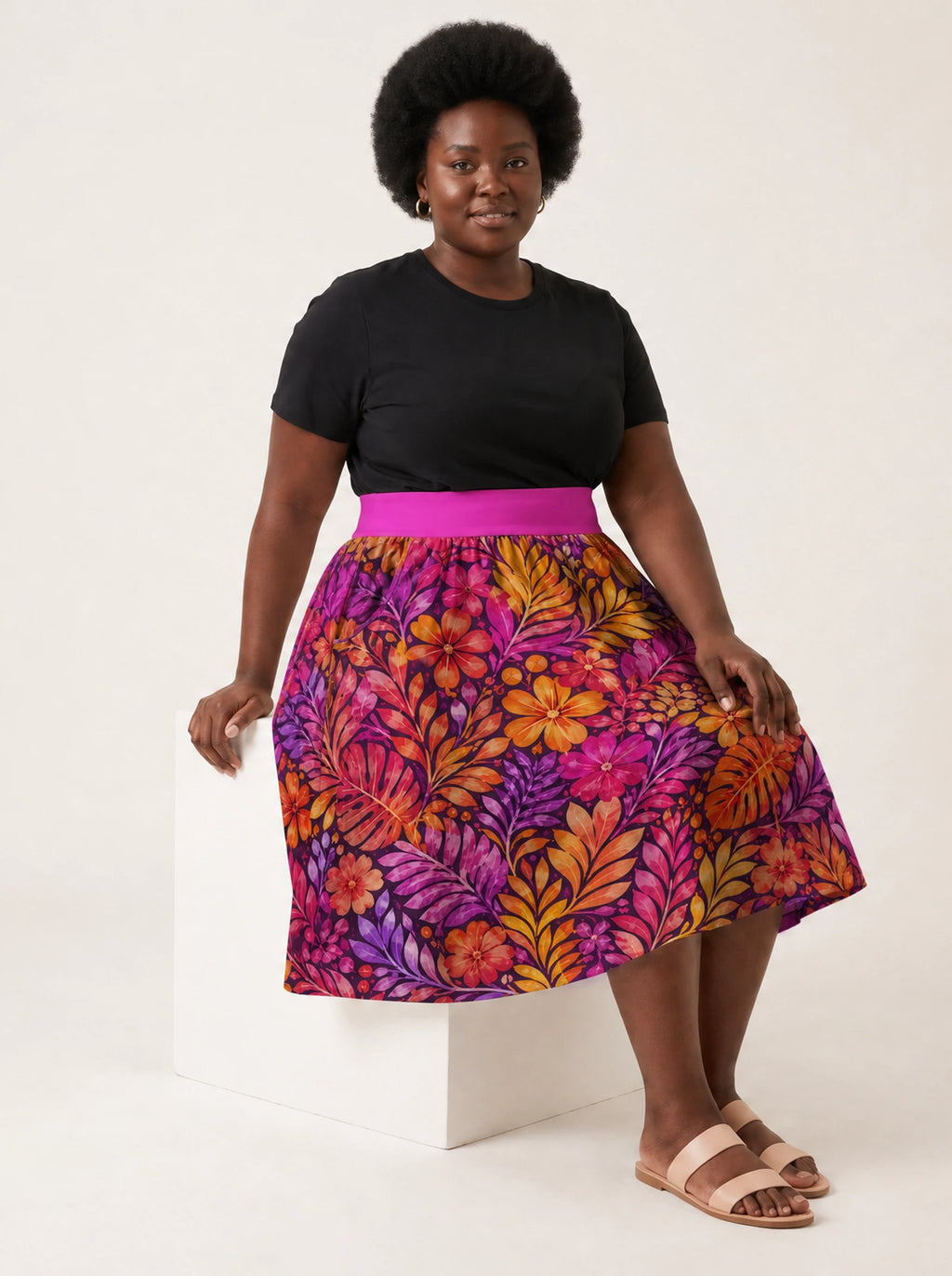 "Waridi" Twirl Skirt — seated on a studio cube