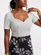 "Kivuli" Sweetheart Midi Dress — close-up of the sweetheart neckline and short sleeve