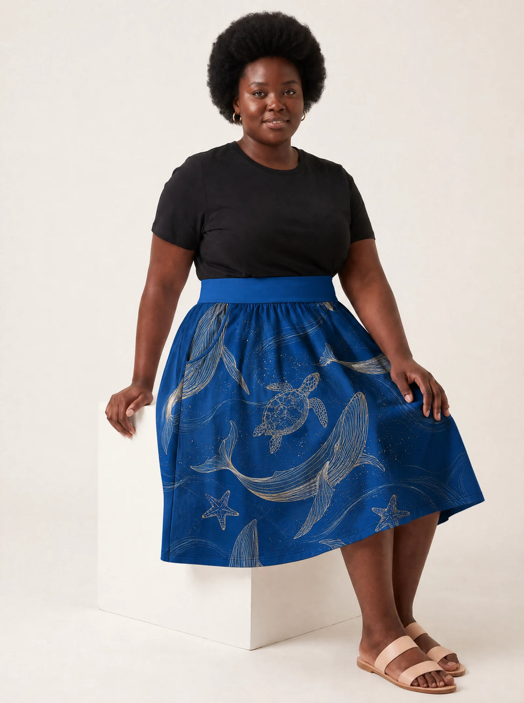 "Pwani" Twirl Skirt — seated on a studio cube