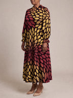"Mavuno" Long Puff Sleeve Dress — three-quarter view on model