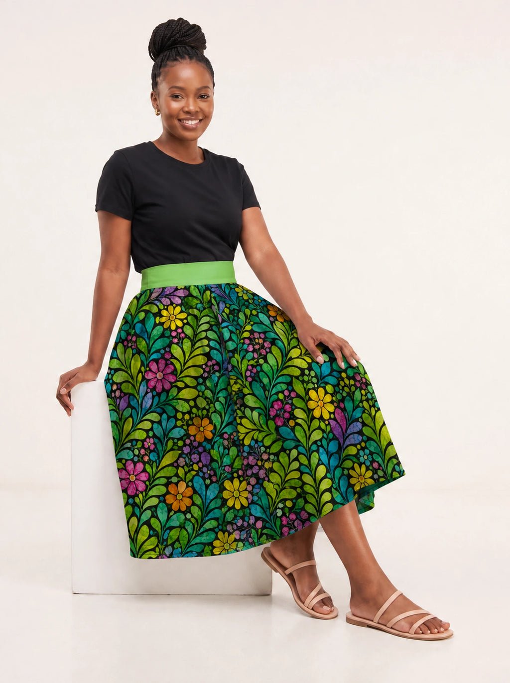 "Zumaridi" Twirl Skirt — seated on a studio cube