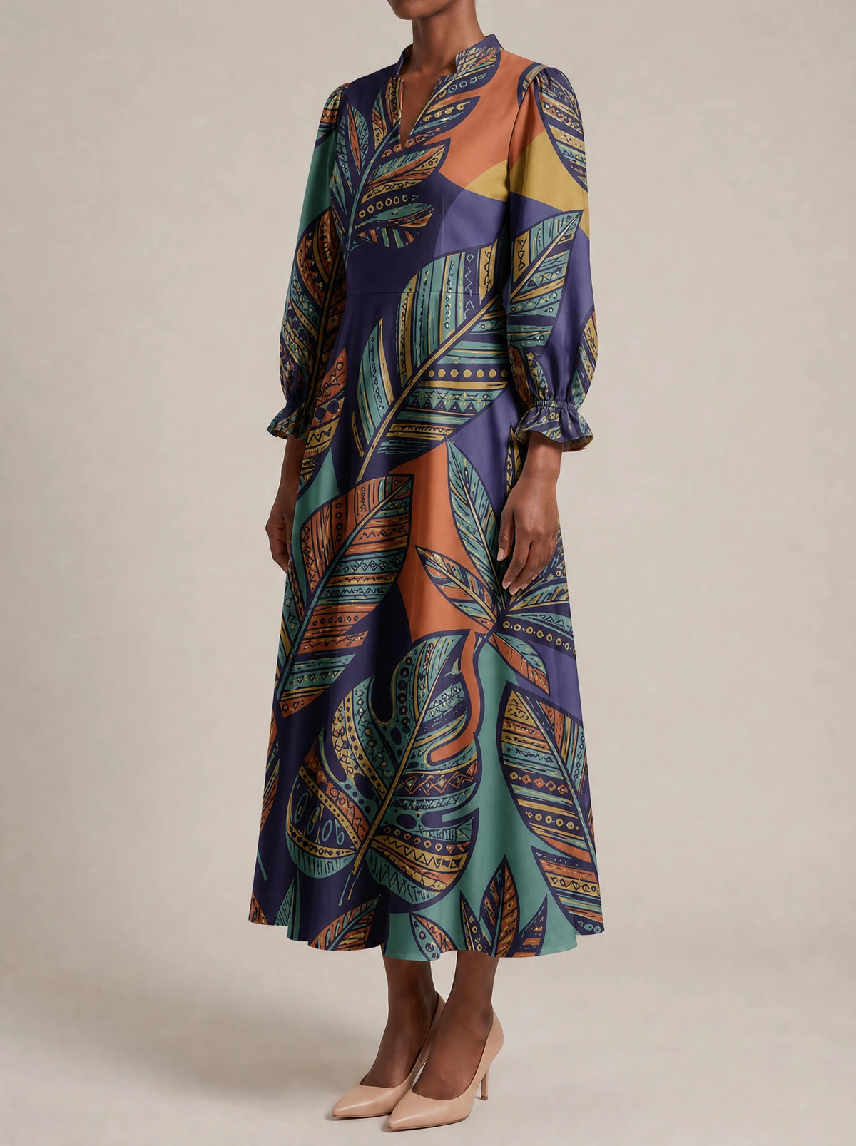 "Majani" Long Puff Sleeve Dress — three-quarter view on model