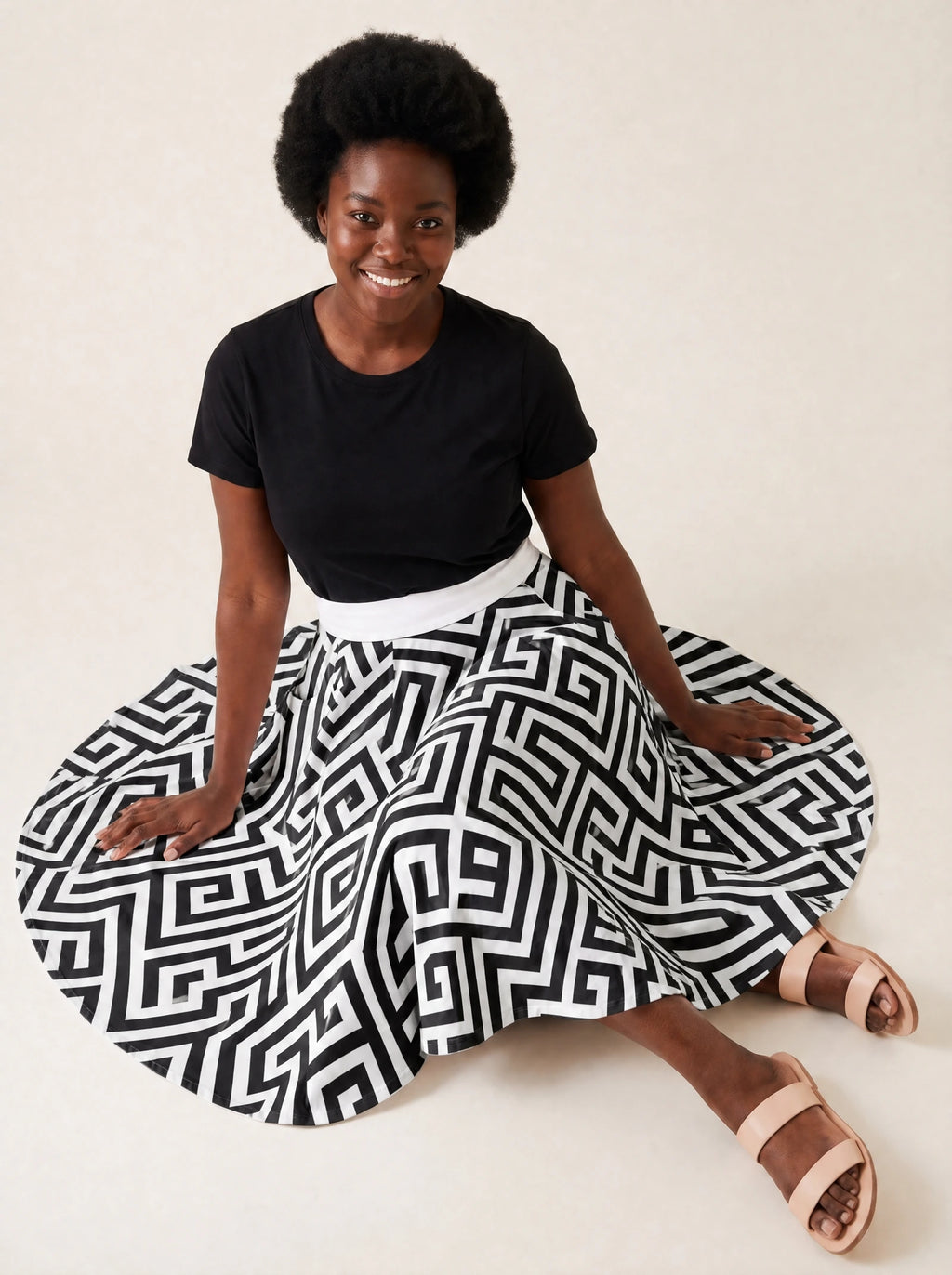 "Zamu" Twirl Skirt — seated on the floor with the skirt fanned out