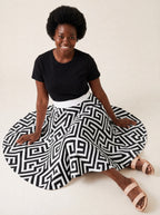 "Zamu" Twirl Skirt — seated on the floor with the skirt fanned out