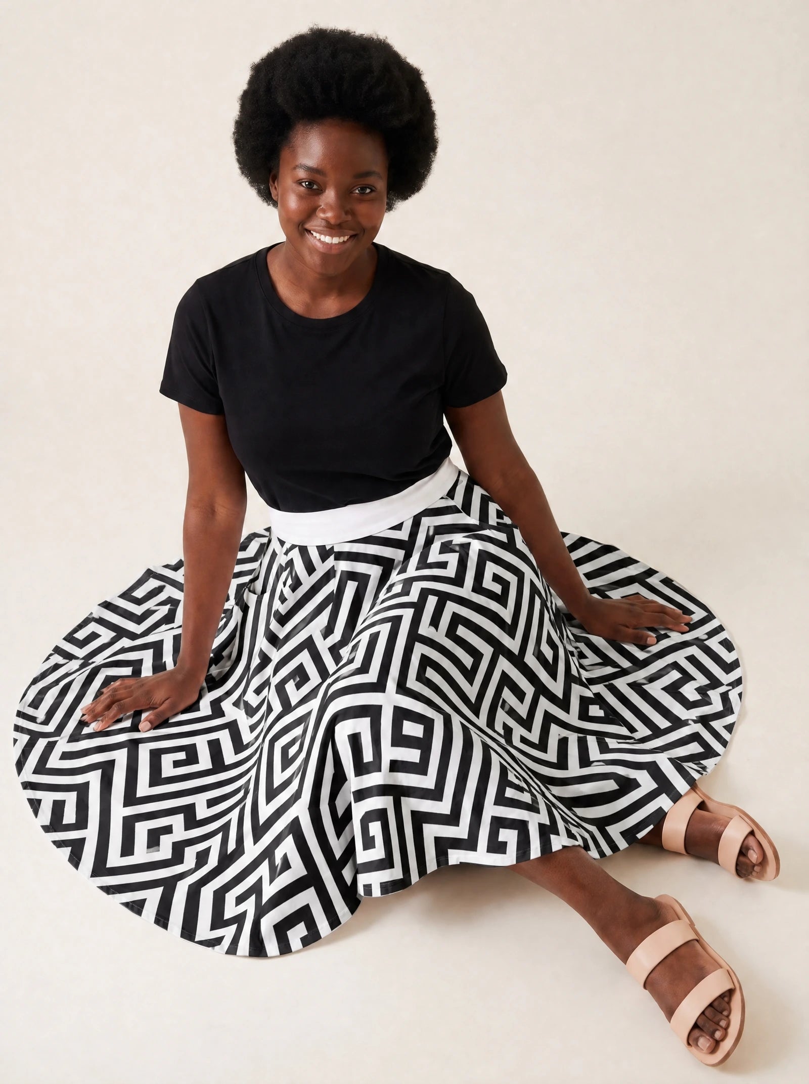 "Zamu" Twirl Skirt — seated on the floor with the skirt fanned out