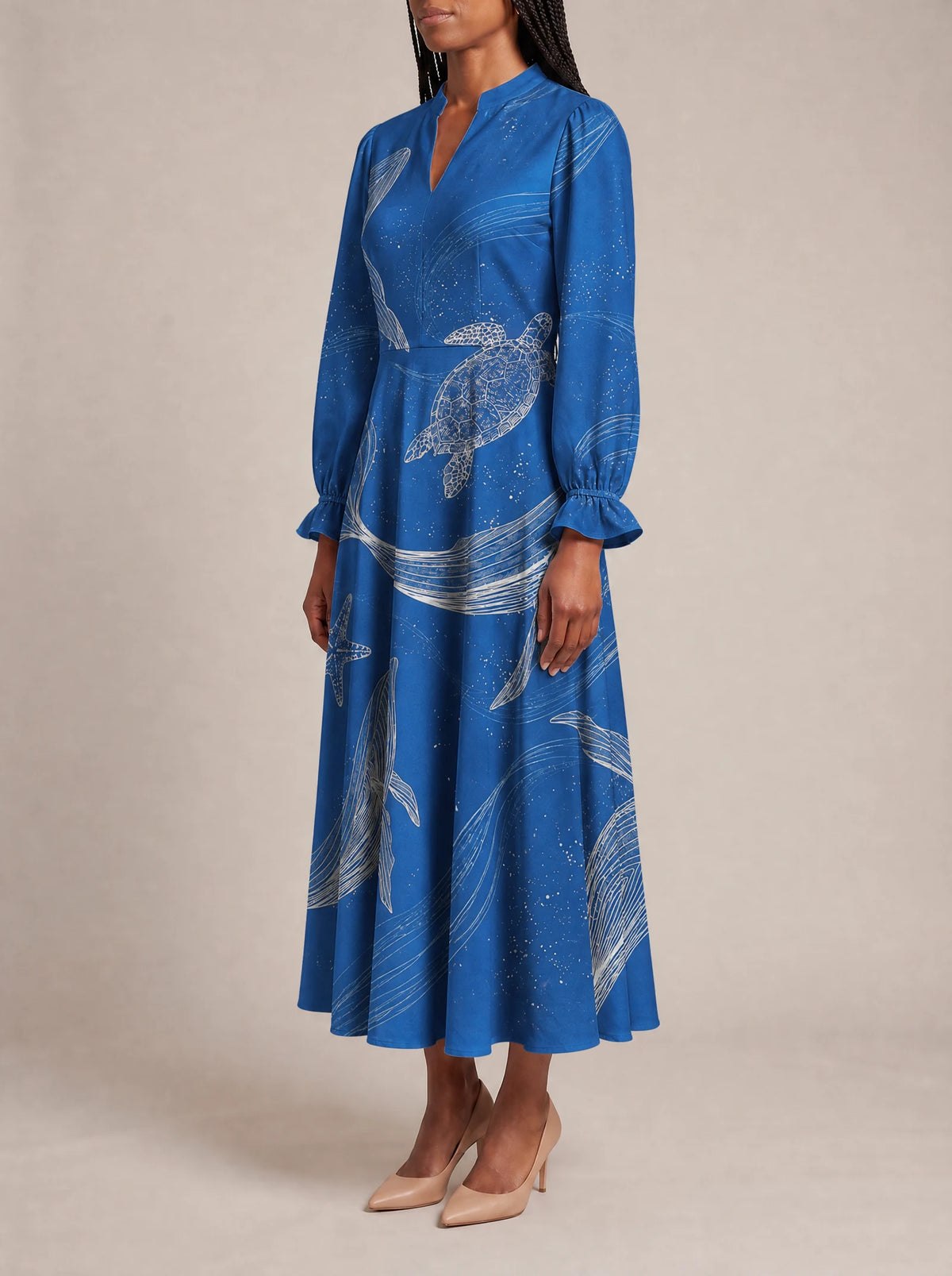"Pwani" Long Puff Sleeve Dress — three-quarter view on model