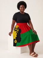 "Furaha" Twirl Skirt — seated on a studio cube