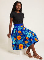 "Maua" Twirl Skirt — seated on a studio cube