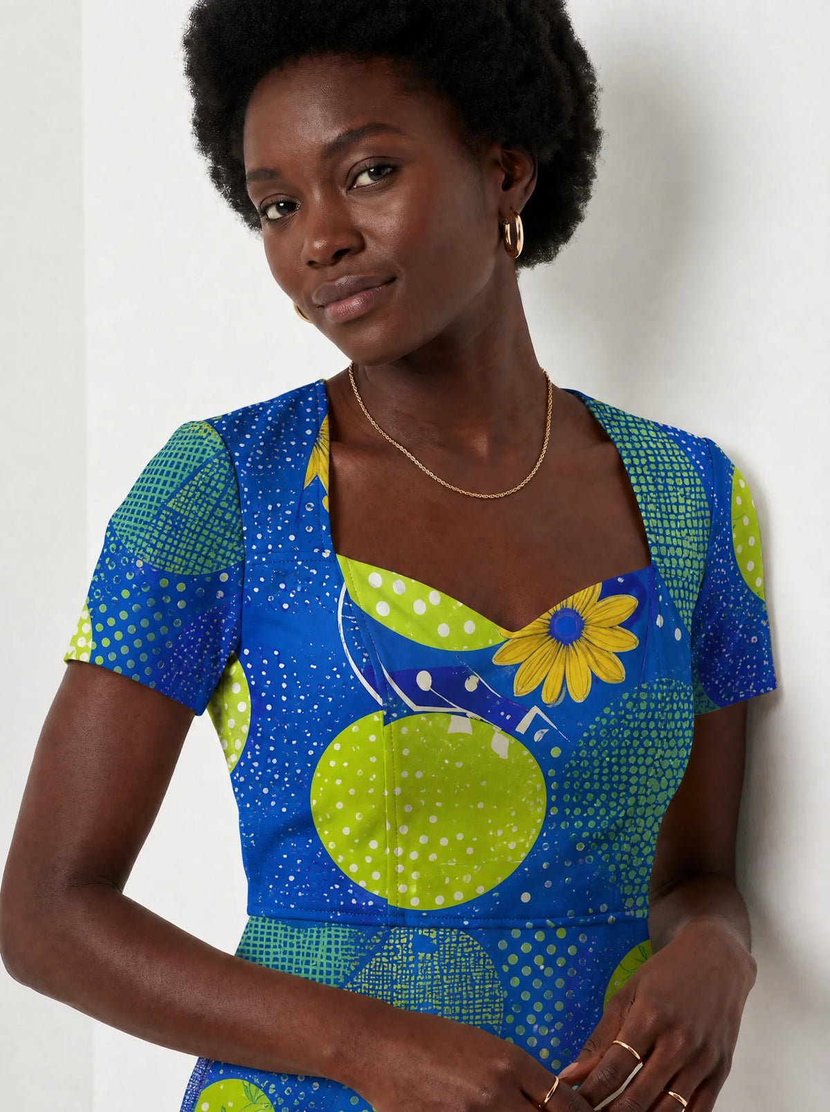 "Mchezo" Sweetheart Midi Dress — close-up of the sweetheart neckline and short sleeve