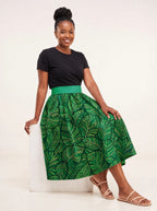 "Asili Emerald" Twirl Skirt — seated on a studio cube