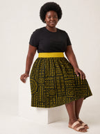 "Lamu" Twirl Skirt — seated on a studio cube