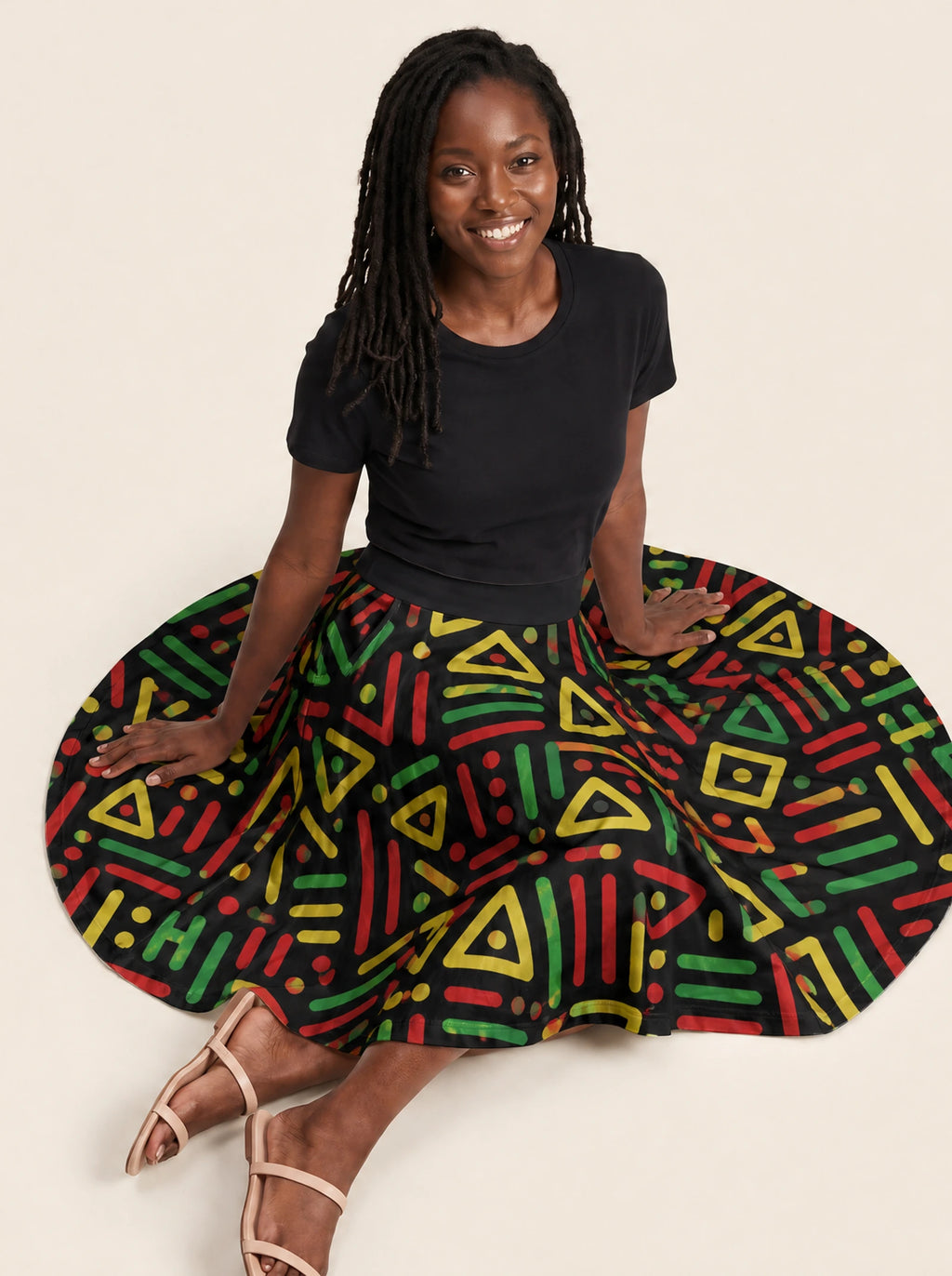 "Nairobi" Twirl Skirt — seated on the floor with the skirt fanned out
