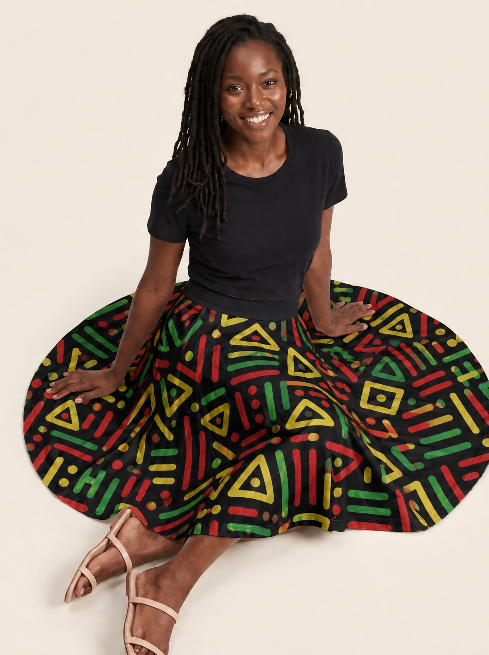"Nairobi" Twirl Skirt — seated on the floor with the skirt fanned out