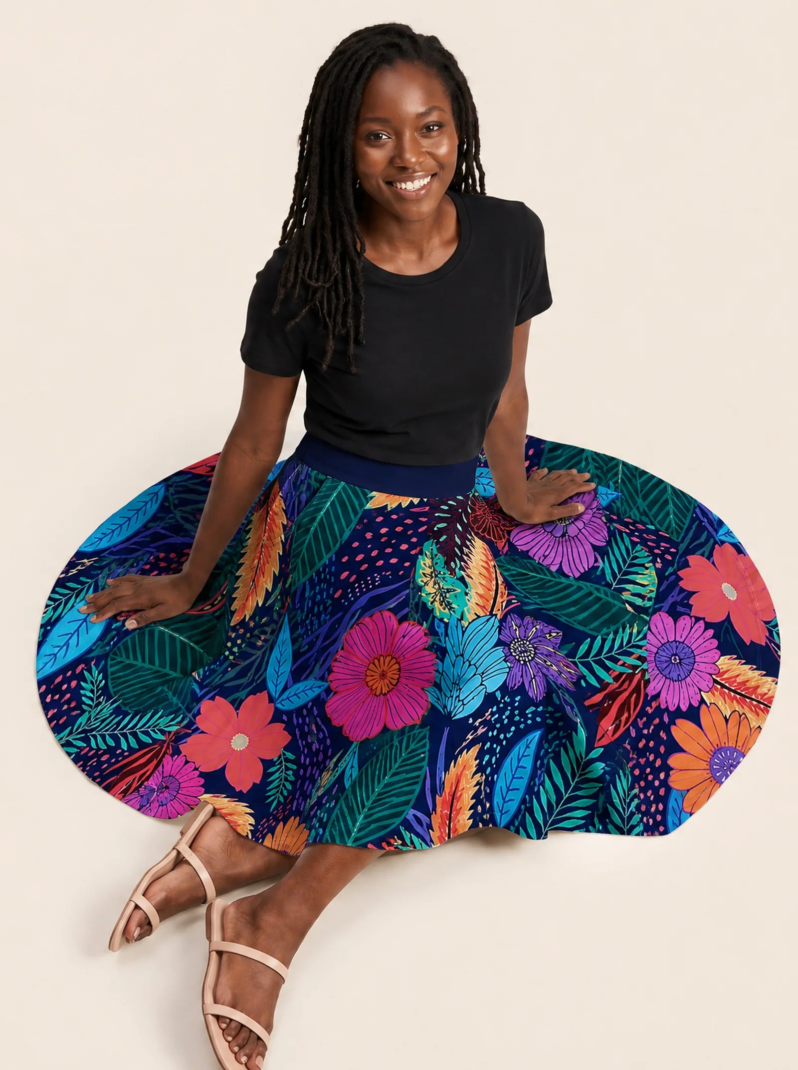 "Bustani" Twirl Skirt — seated on the floor with the skirt fanned out