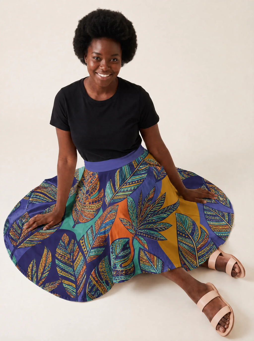 "Majani" Twirl Skirt — seated on the floor with the skirt fanned out