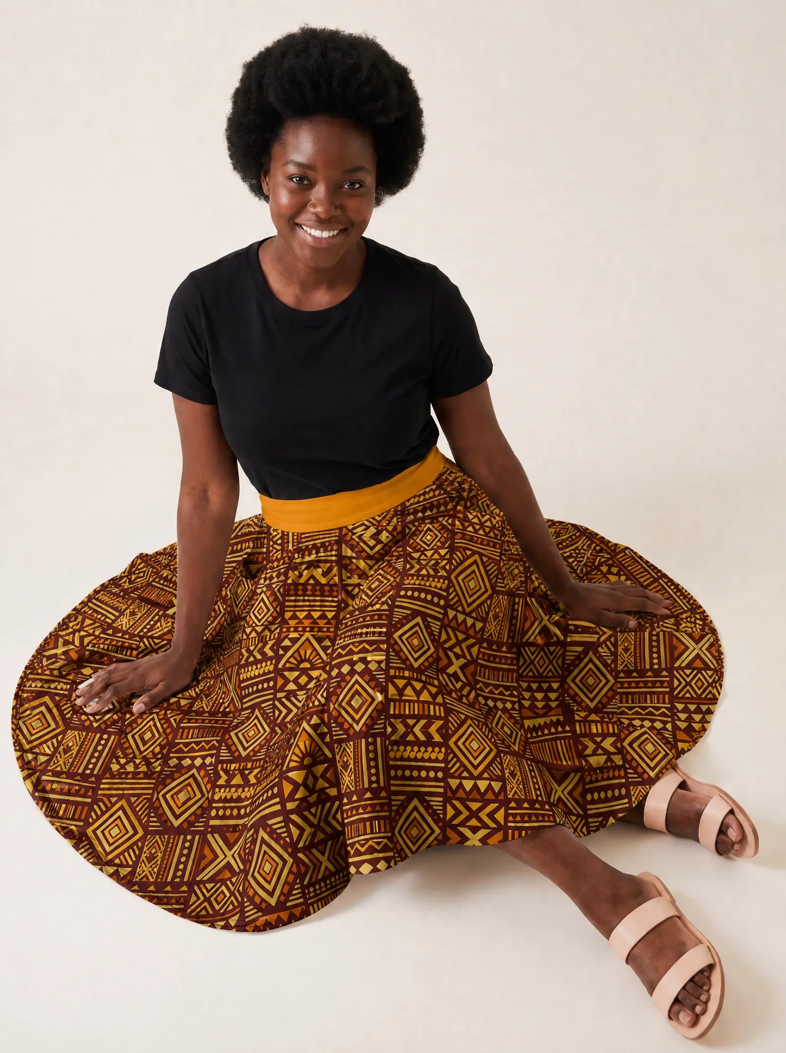 "Mudcloth" Twirl Skirt — seated on the floor with the skirt fanned out